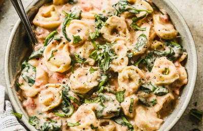 Cheese Tortellini Served with Creamy Tomato and Spinach Sauce
